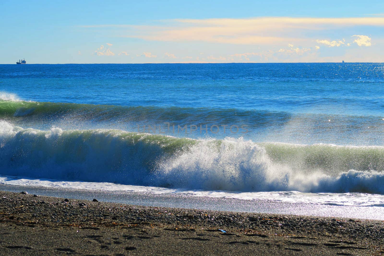 Double wave breaking on the beach in Savona,Liguria,Italy