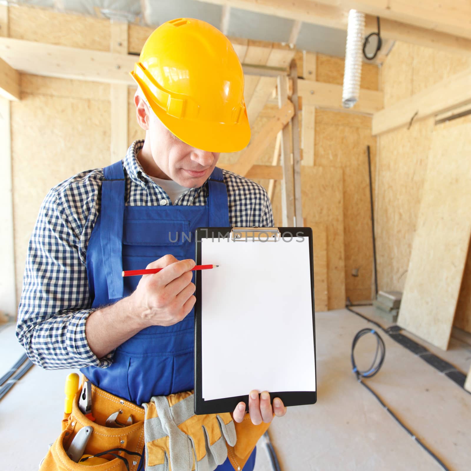 Portrait of foreman pointing at white folder plate