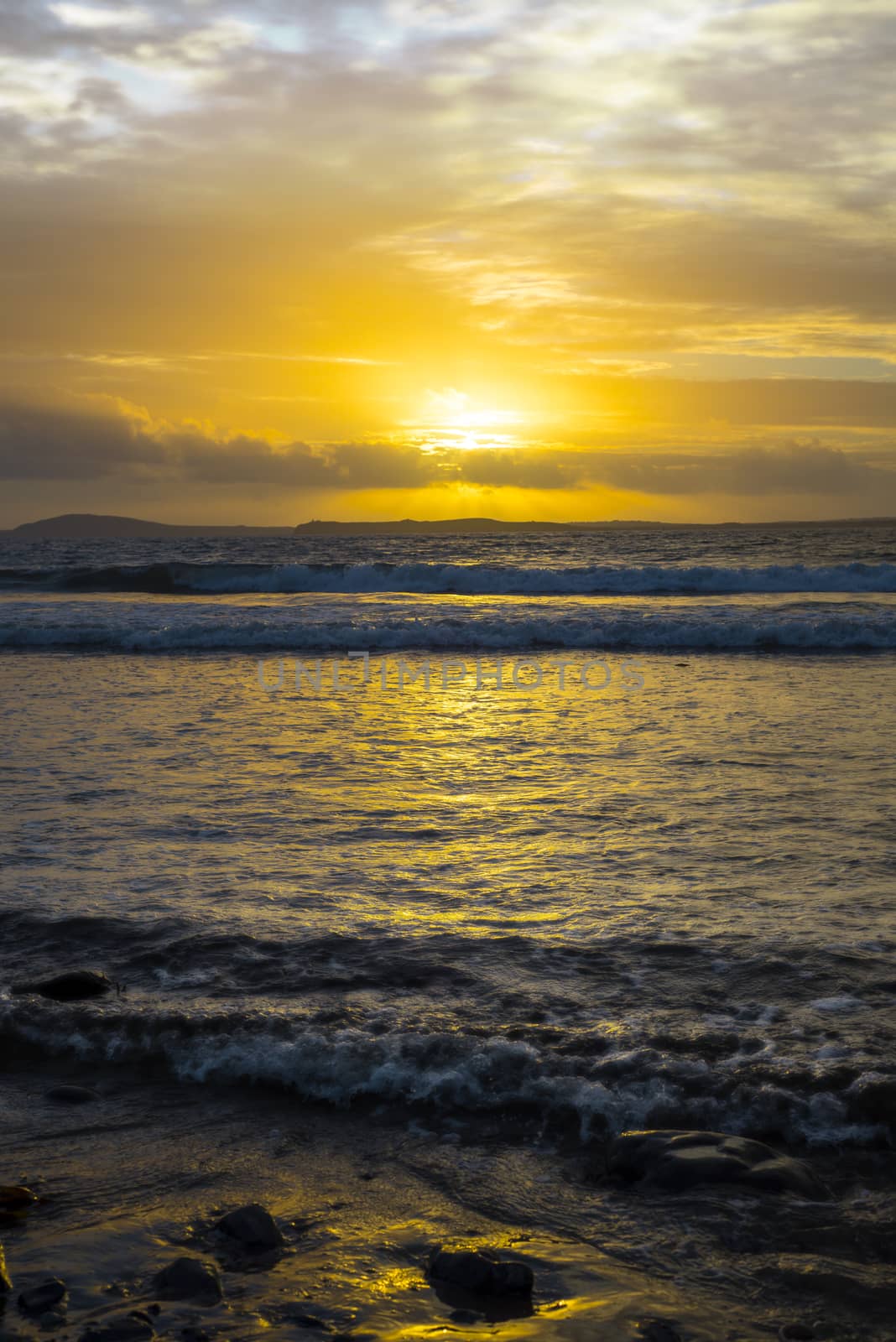 beautiful yellow sunset and soft waves at beal beach by morrbyte