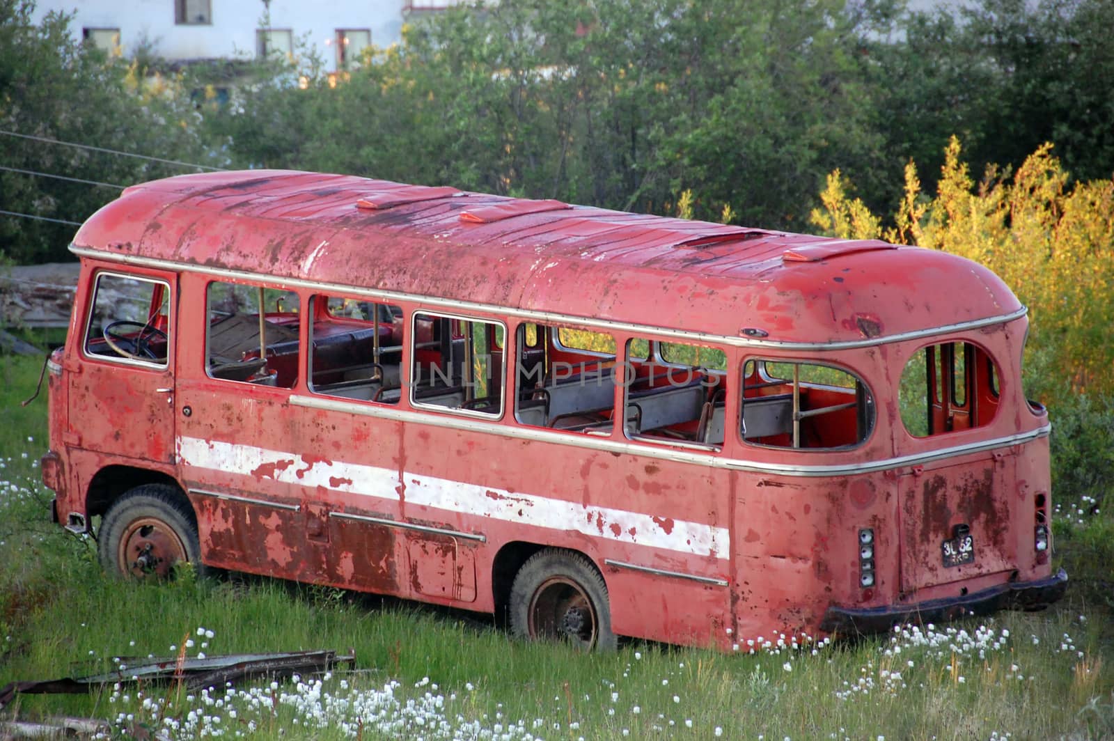 Abandoned broken red bus at Chersky town, Russia