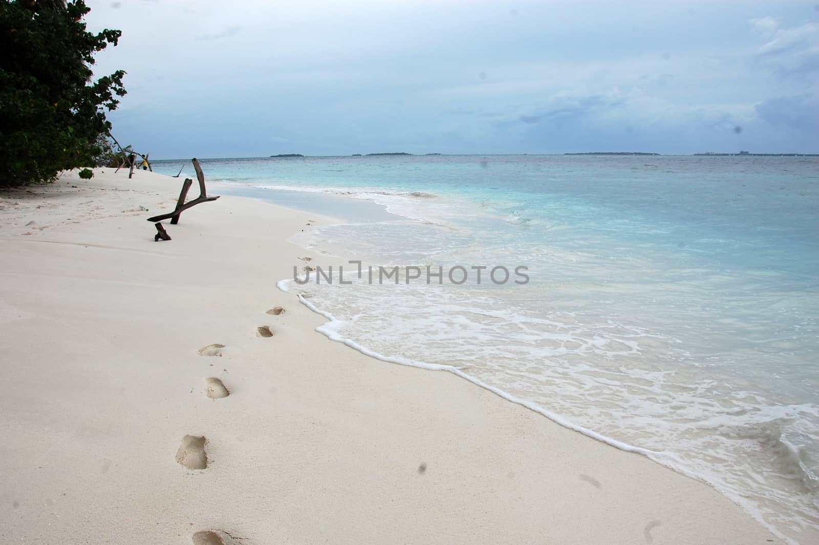 Footsteps at white sand beach Maldives, Indian Ocean