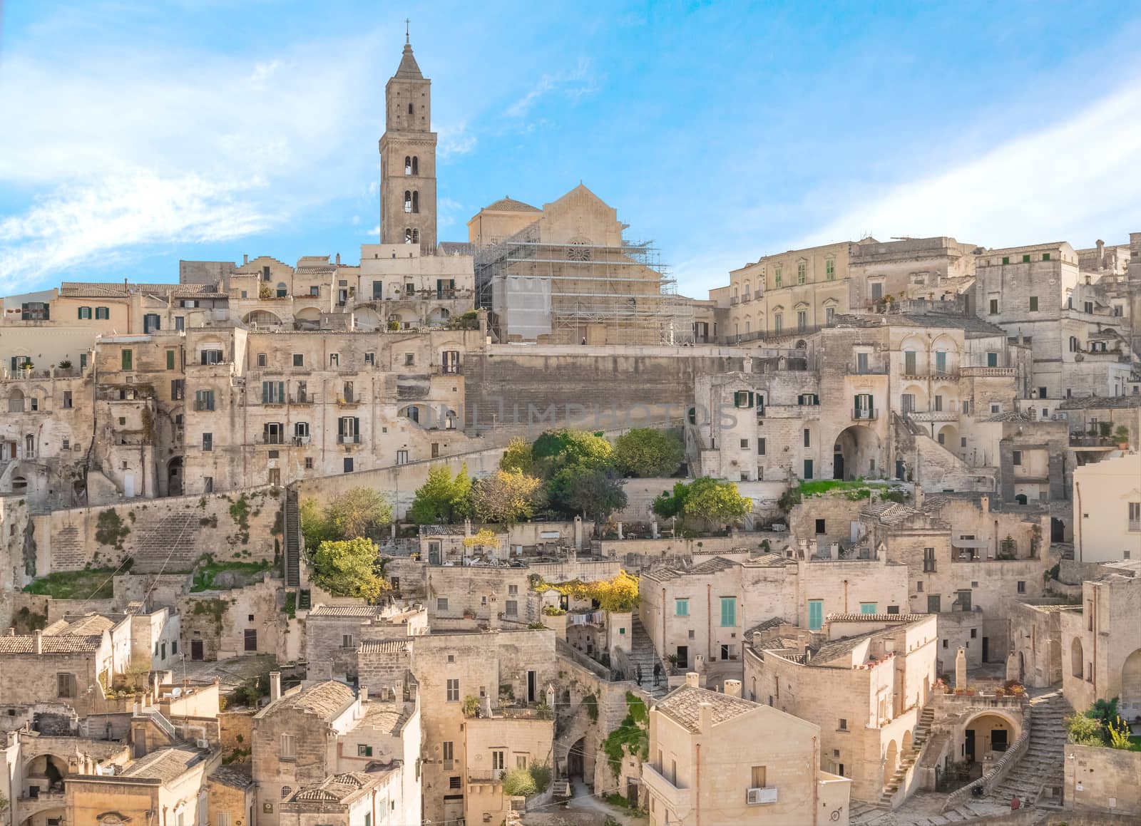 panoramic view of typical stones (Sassi di Matera) and church of Matera UNESCO European Capital of Culture 2019 under blue sky  by donfiore