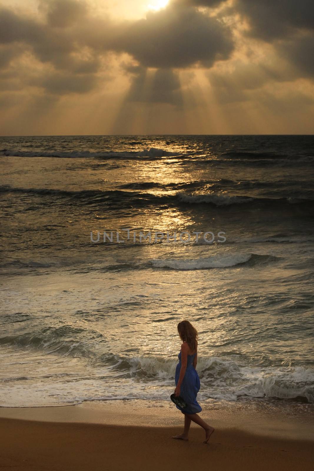 Girl on a beach on sunset by friday