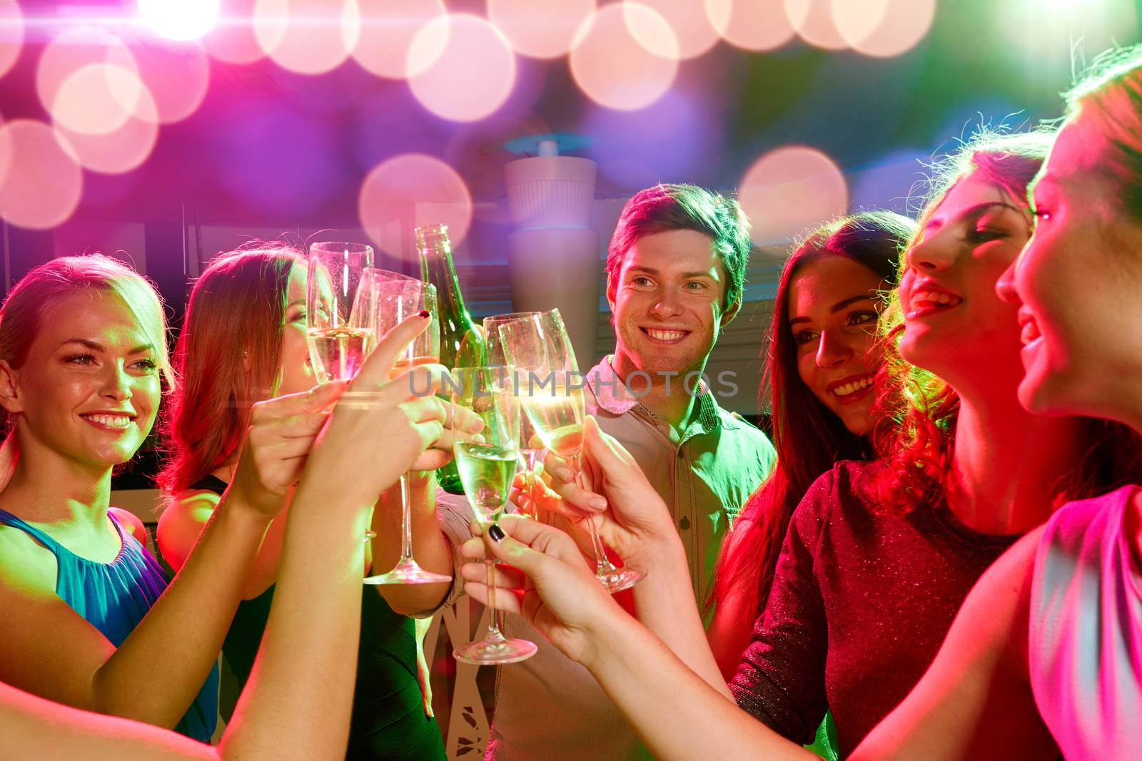 party, holidays, celebration, nightlife and people concept - smiling friends clinking glasses of champagne and beer in club