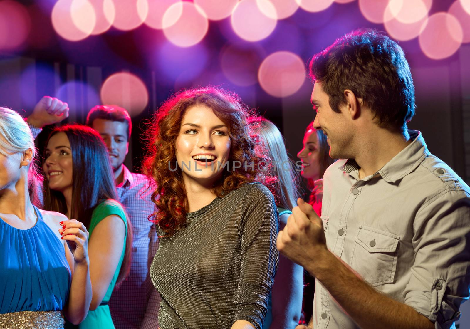 party, holidays, celebration, nightlife and people concept - smiling friends dancing in club