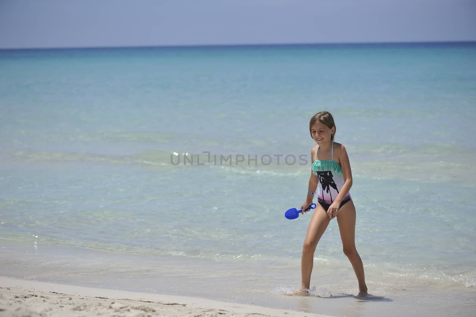 happy small girl has fun in the Caribbean sea.
