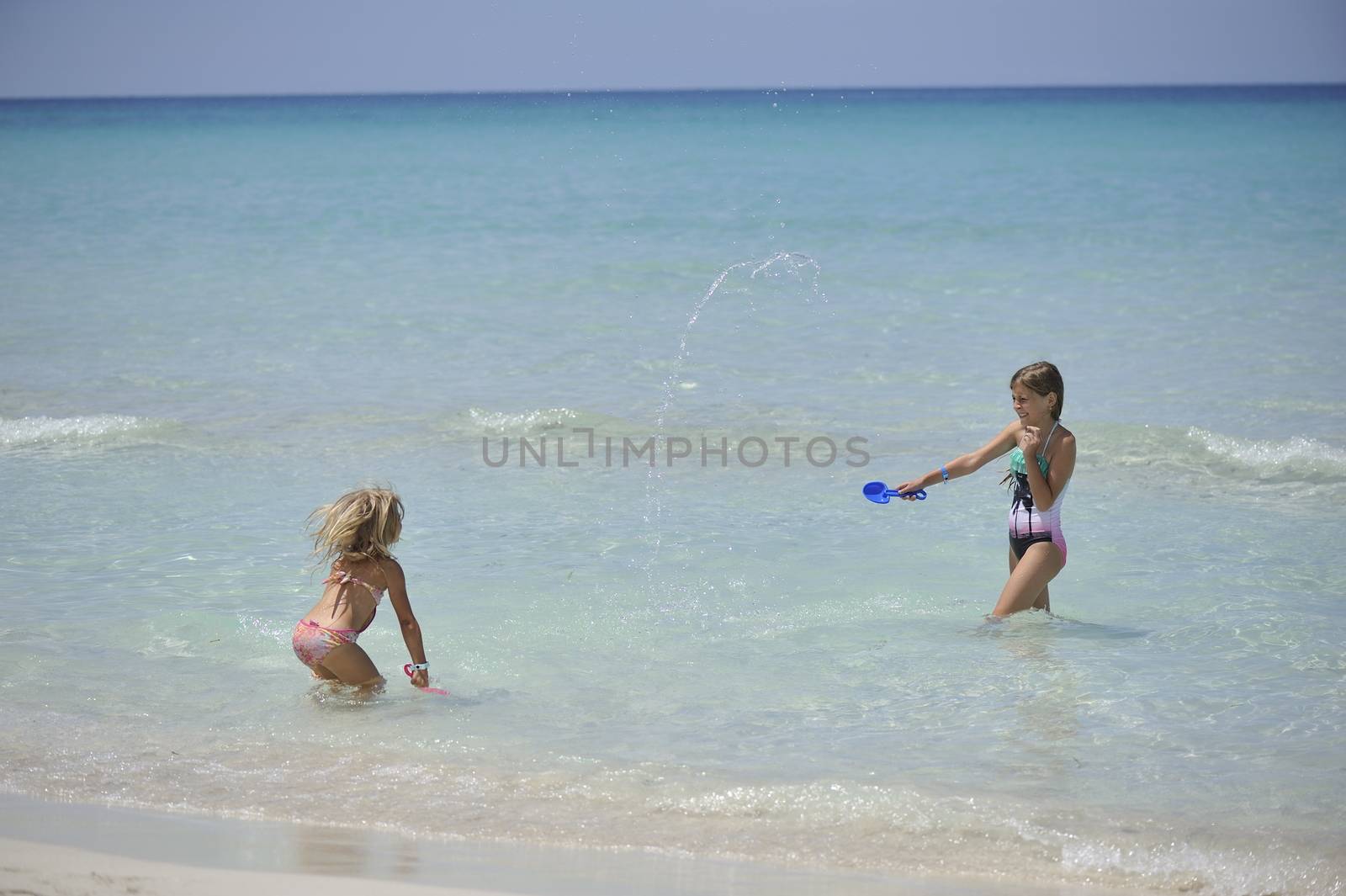 Happy girls have fun in the Caribbean sea.