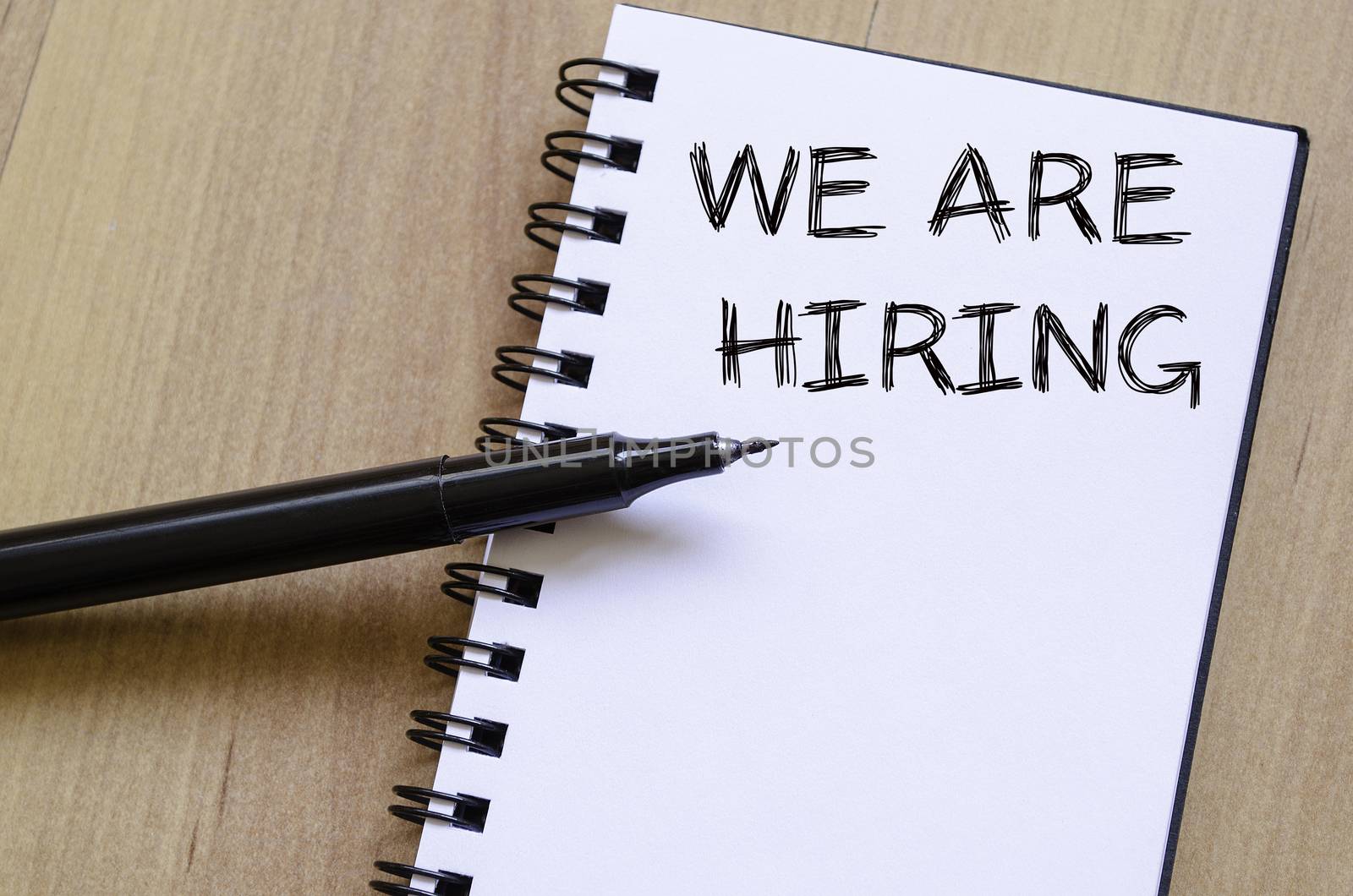 We are hiring text concept write on notebook