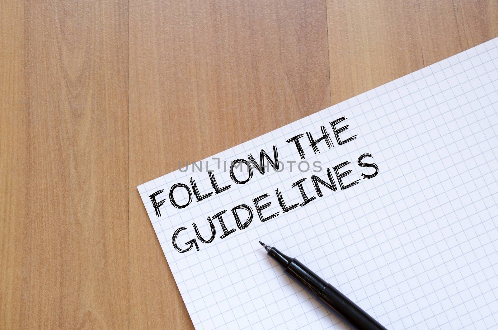 Follow the guidelines text concept write on notebook with pen