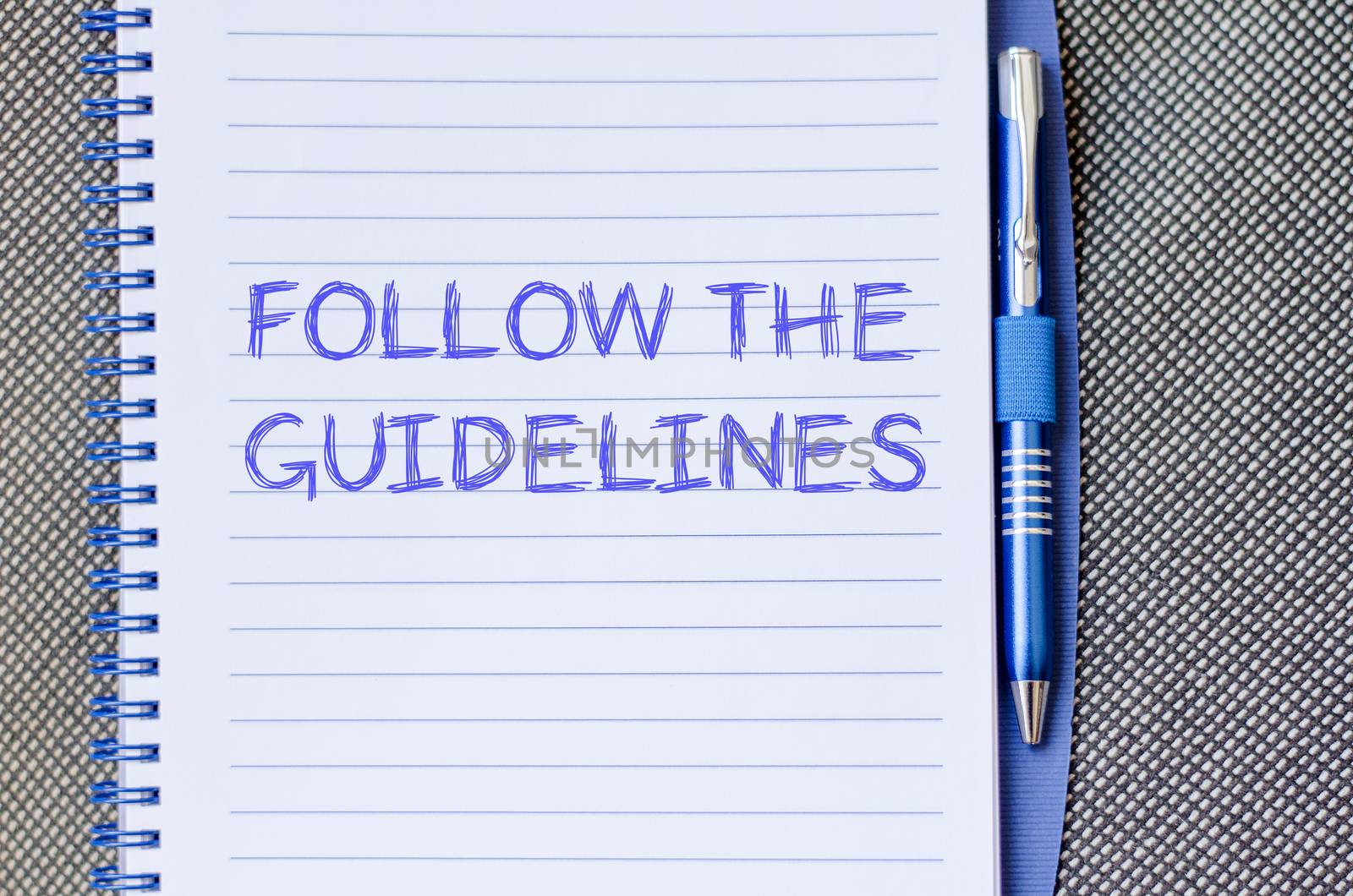 Follow the guidelines text concept write on notebook with pen