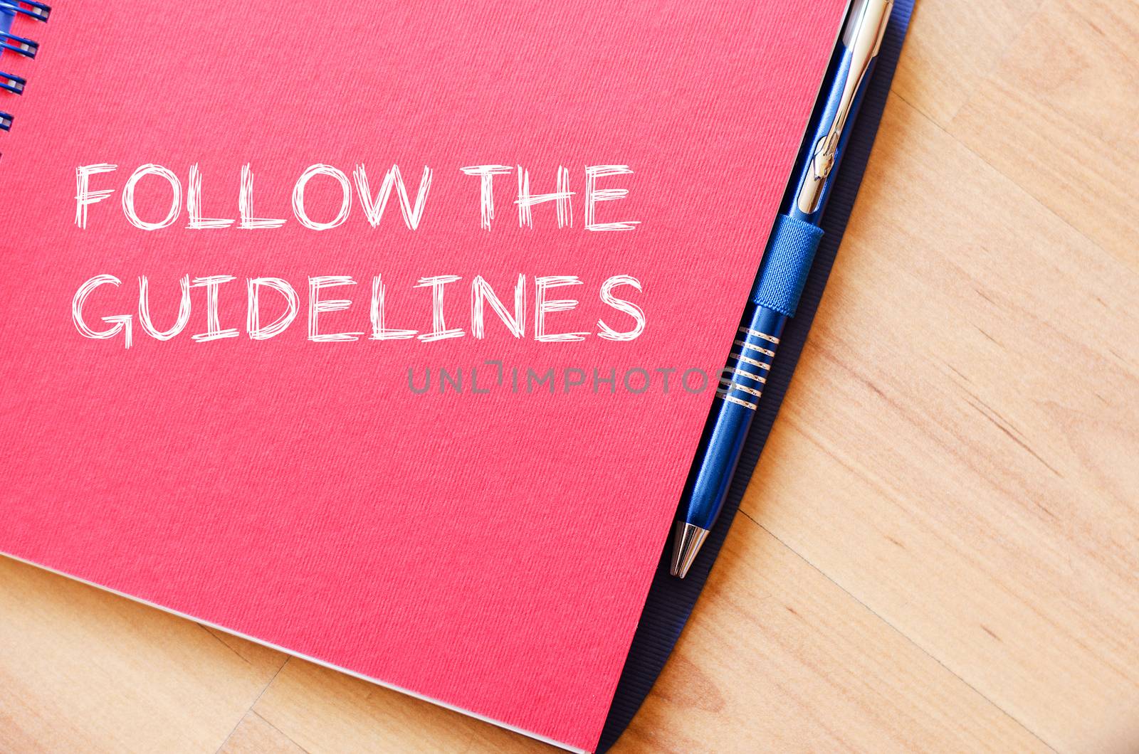Follow the guidelines text concept write on notebook with pen