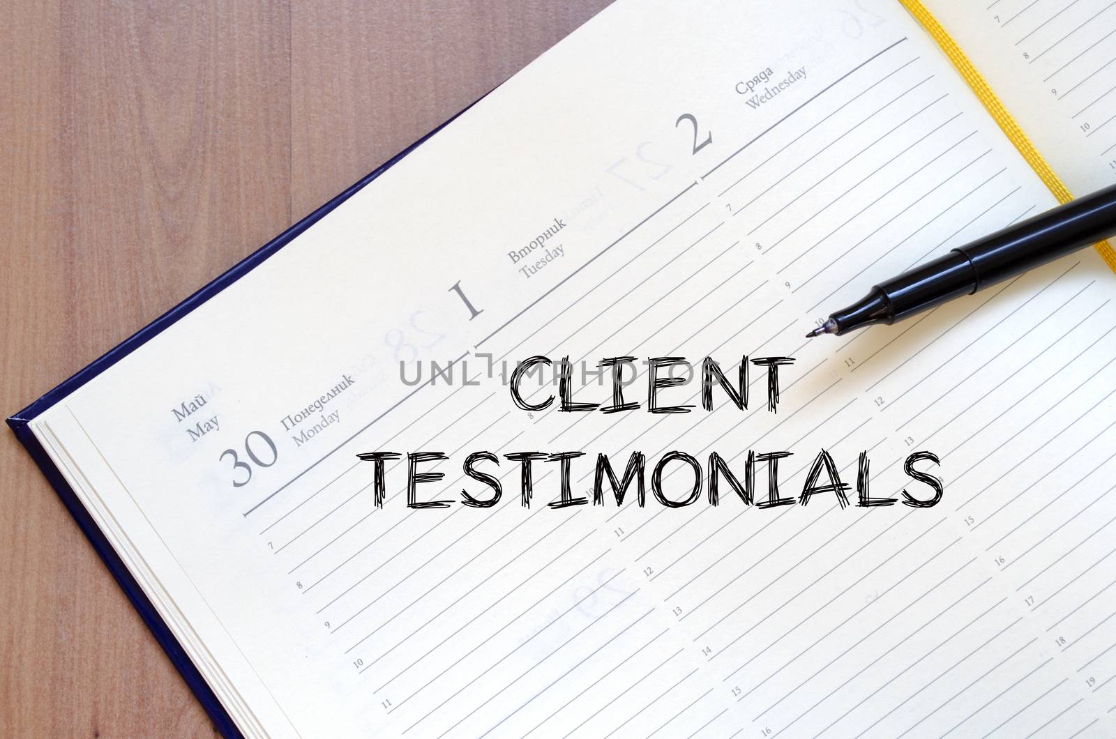 Client testimonials text concept write on notebook with pen