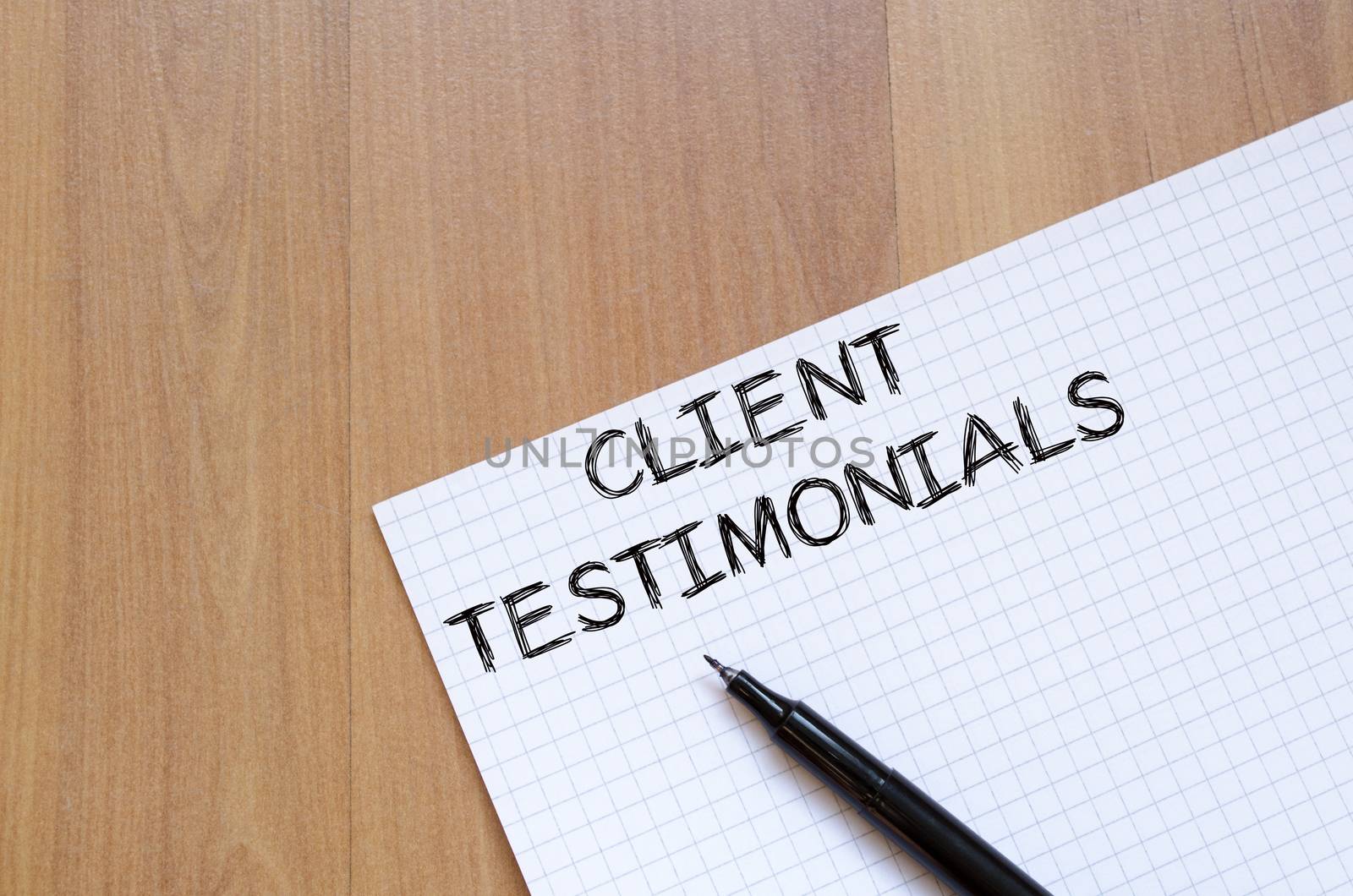 Client testimonials text concept write on notebook with pen