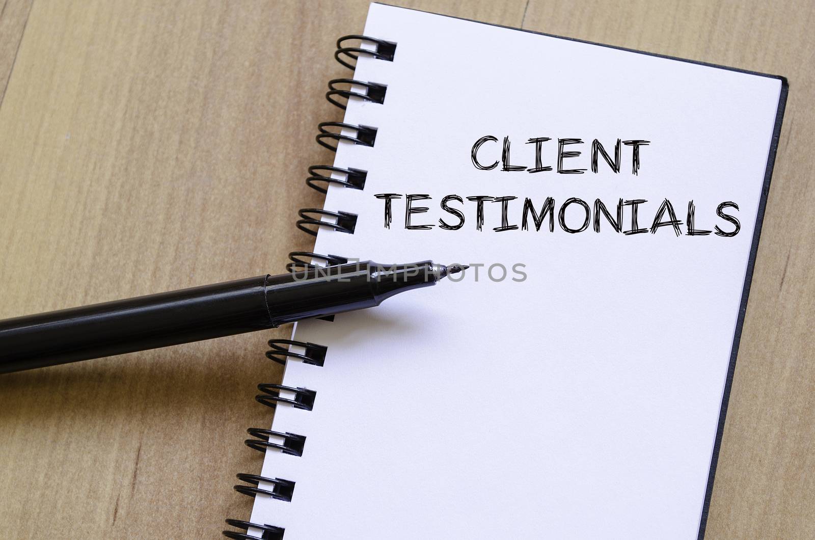 Client testimonials text concept write on notebook with pen