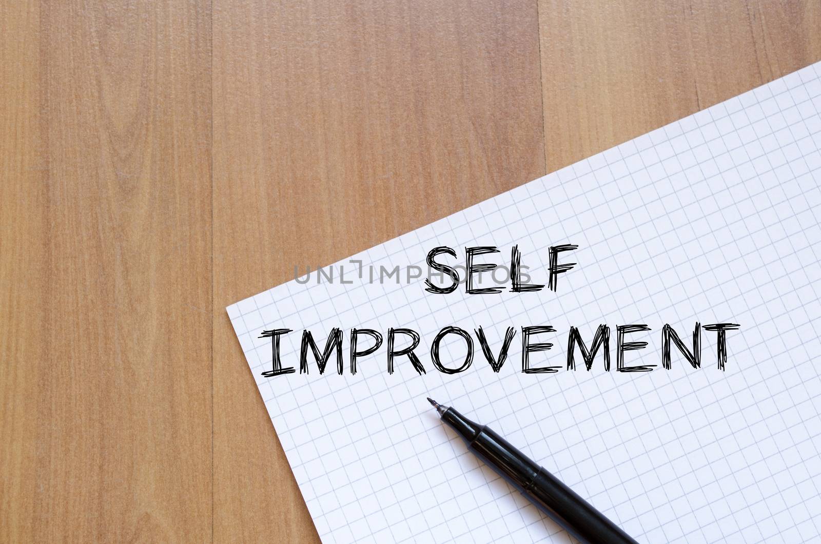 Self improvement text concept write on notebook with pen