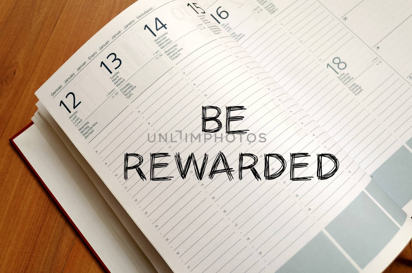 Be rewarded text concept write on notebook with pen