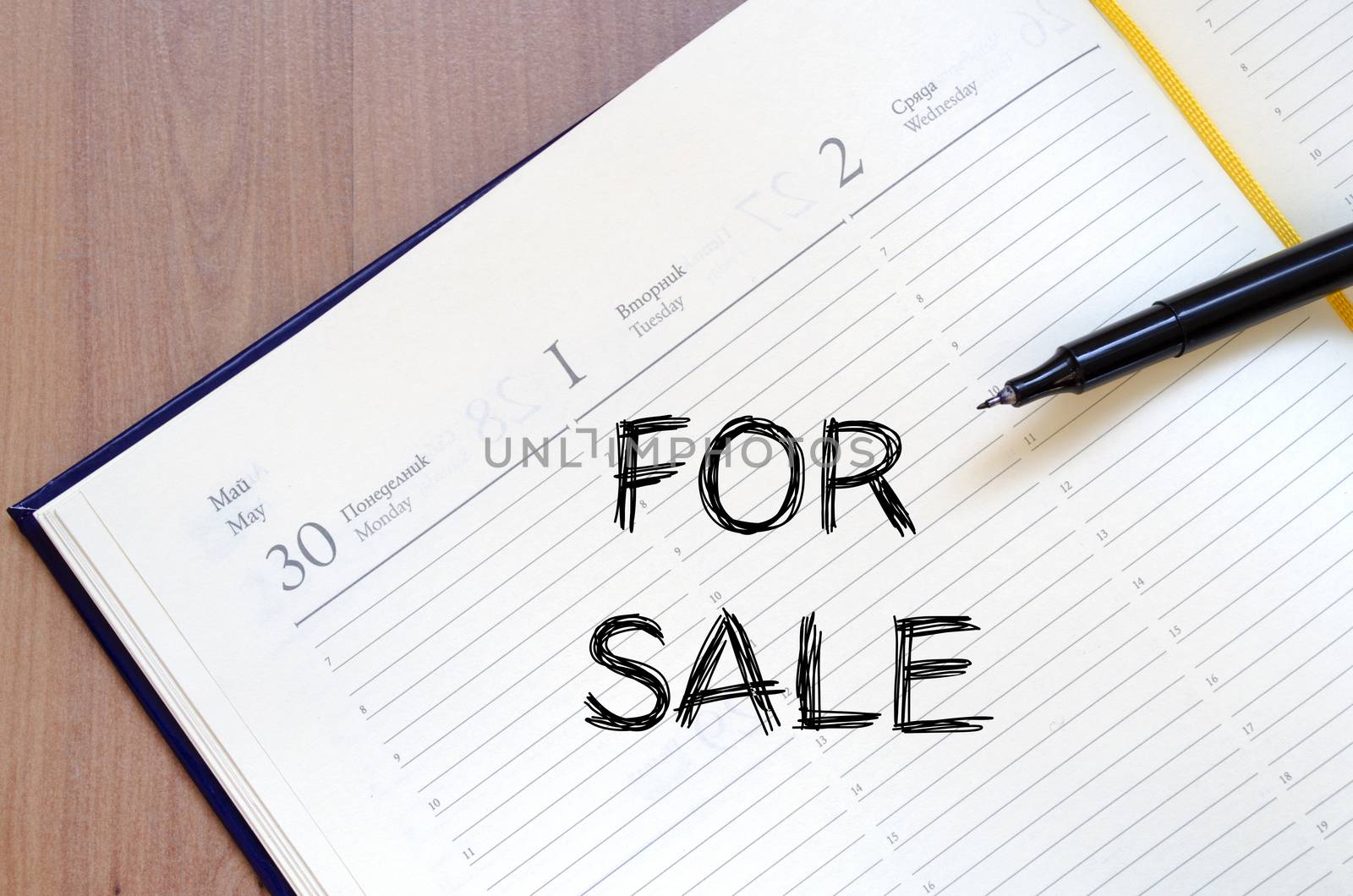 For sale text concept write on notebook with pen