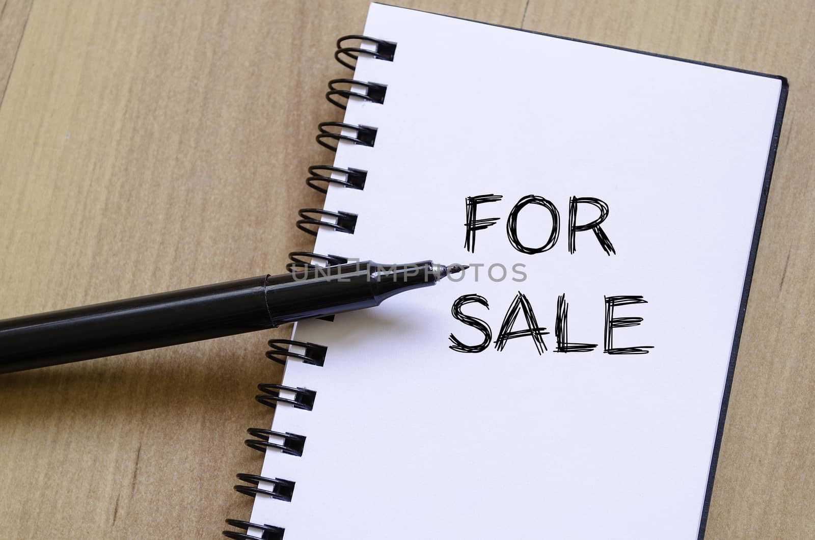 For sale text concept write on notebook with pen