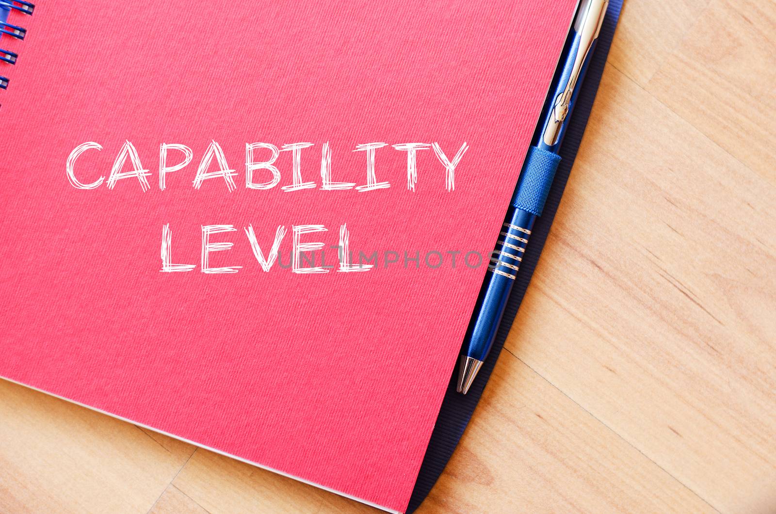 Capability level text concept write on notebook with pen