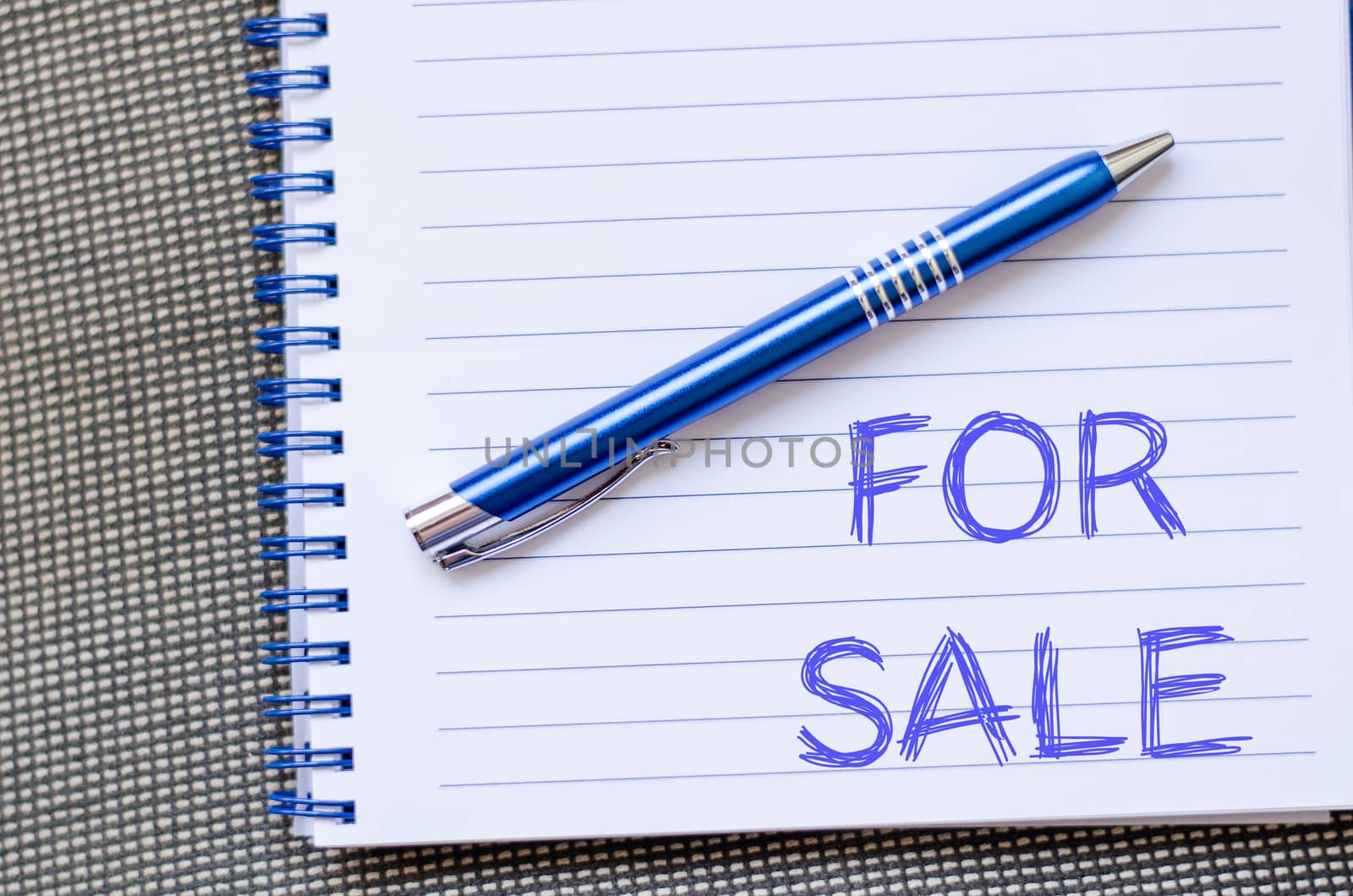 For sale text concept write on notebook with pen