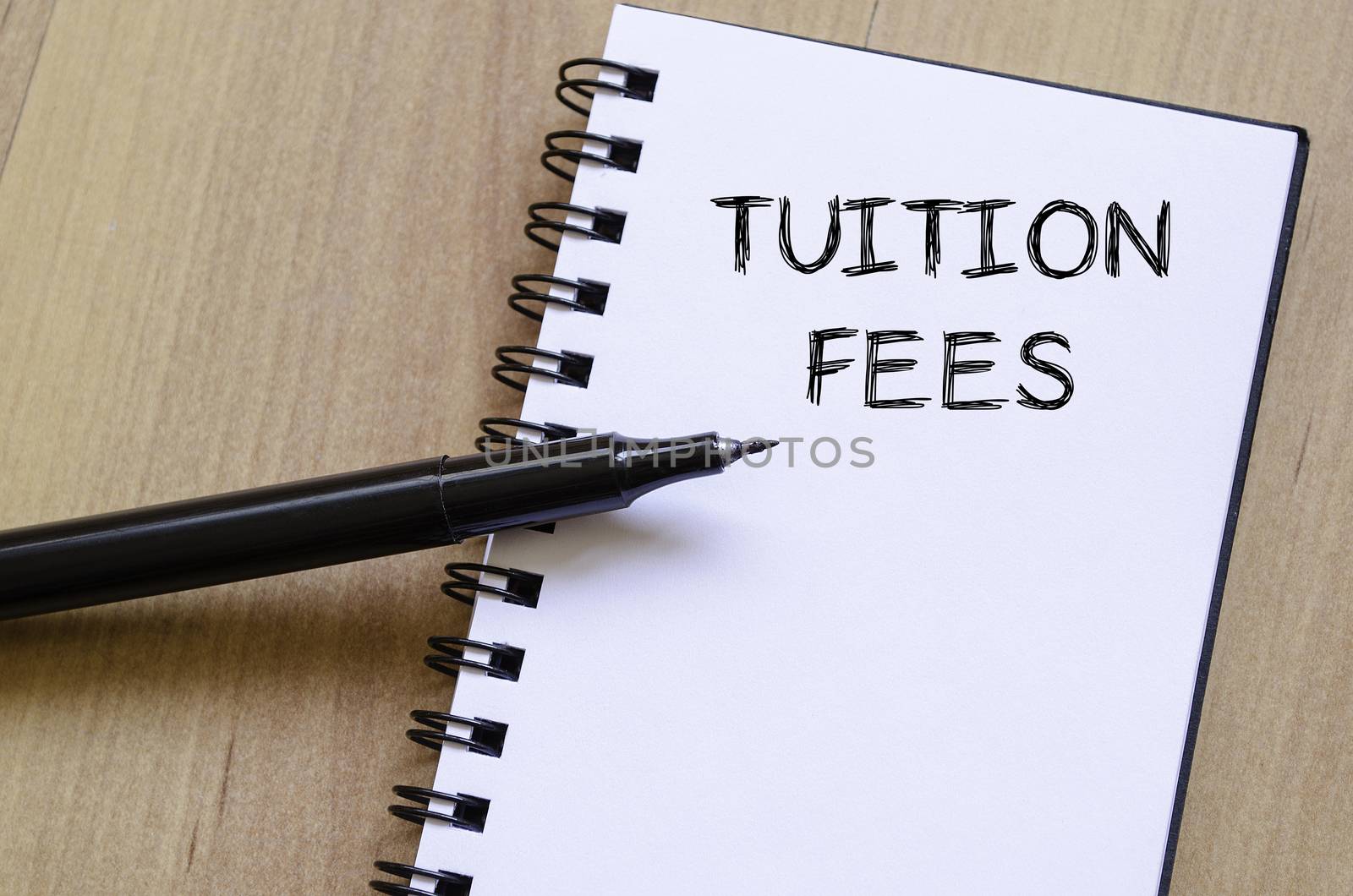 Tuition fees text concept write on notebook with pen