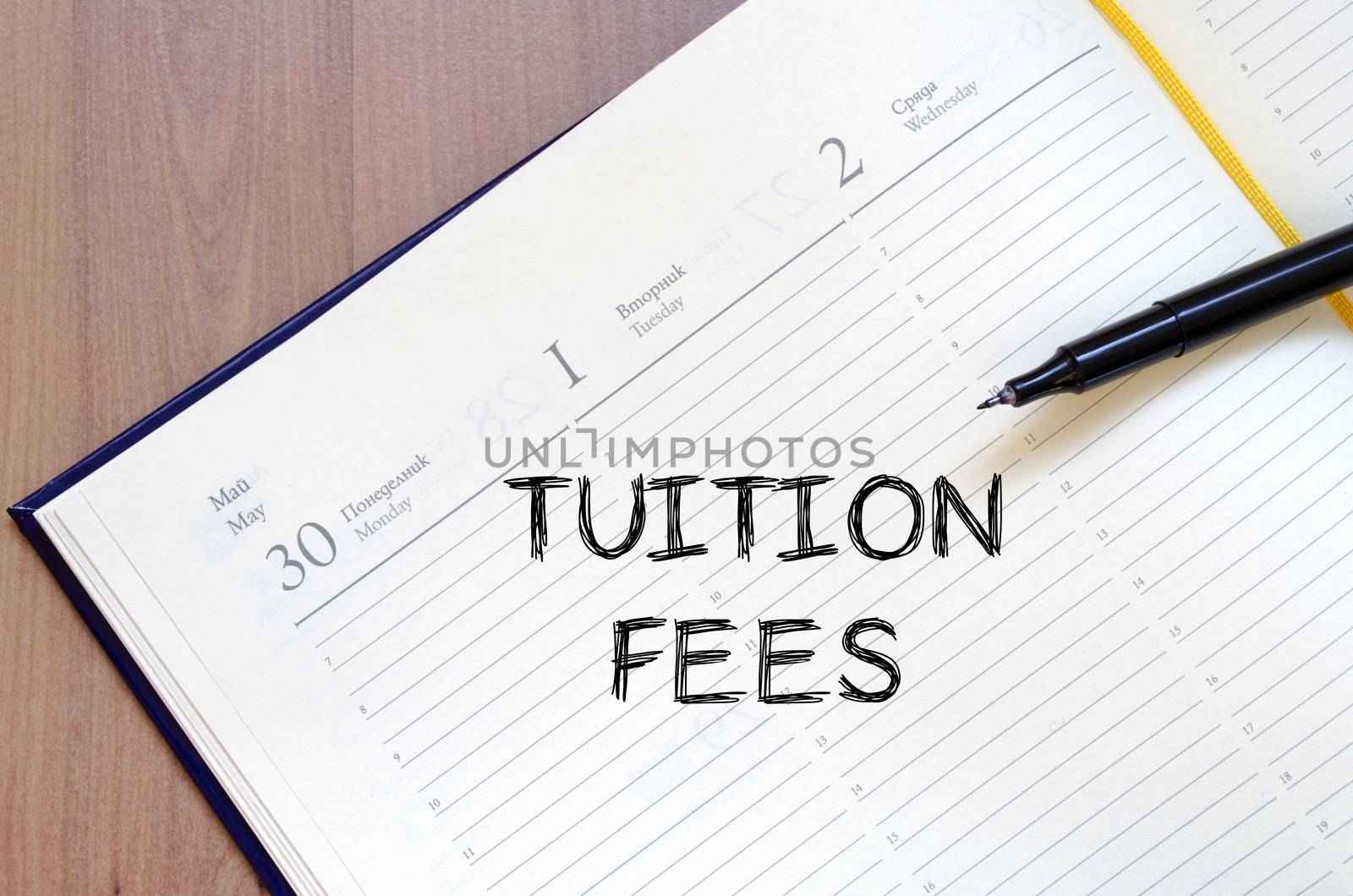 Tuition fees text concept write on notebook with pen