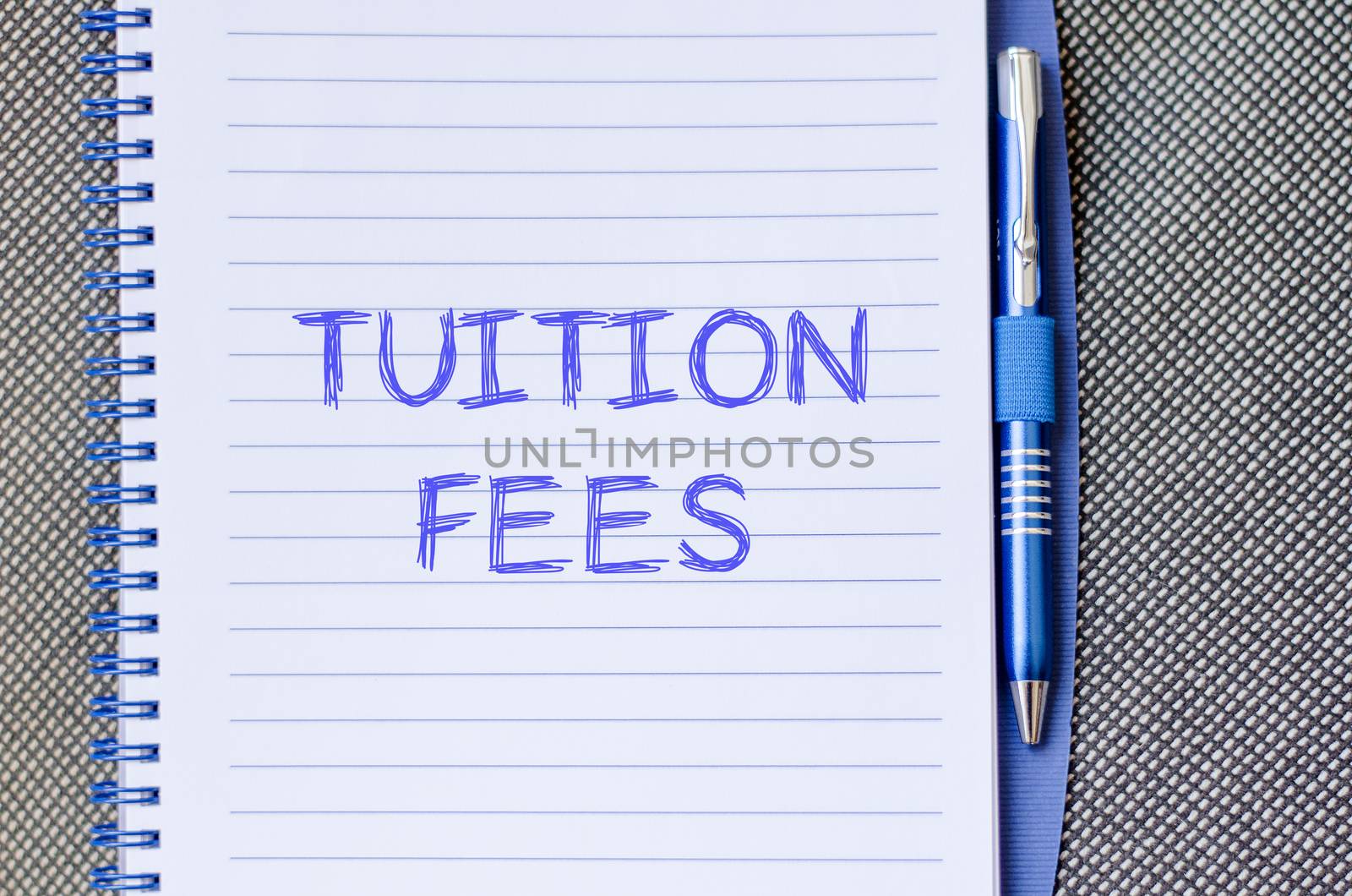 Tuition fees text concept write on notebook with pen