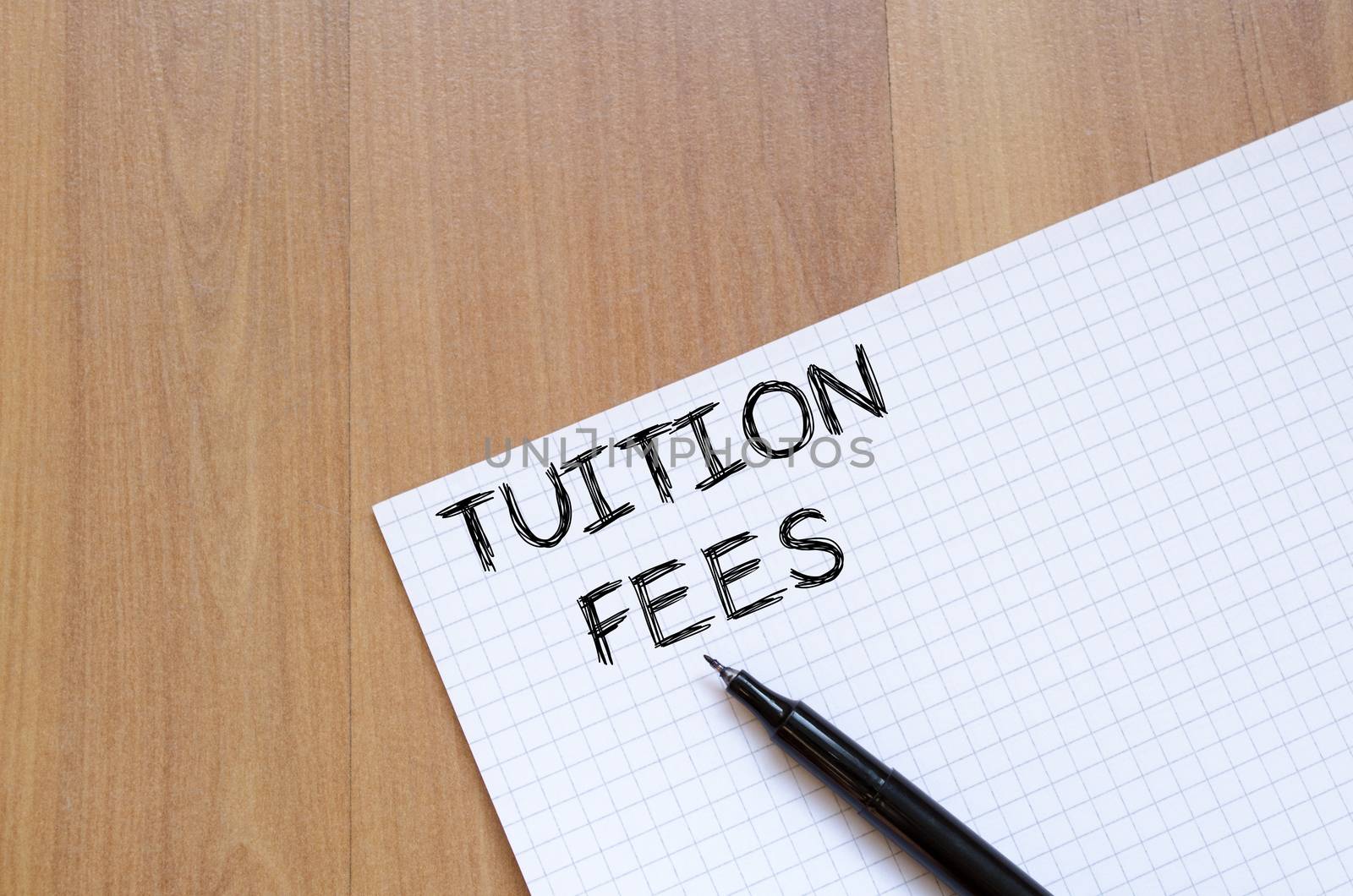 Tuition fees text concept write on notebook with pen