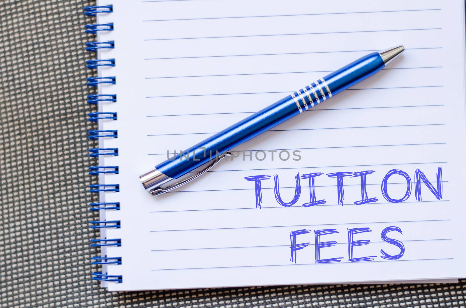 Tuition fees text concept write on notebook with pen