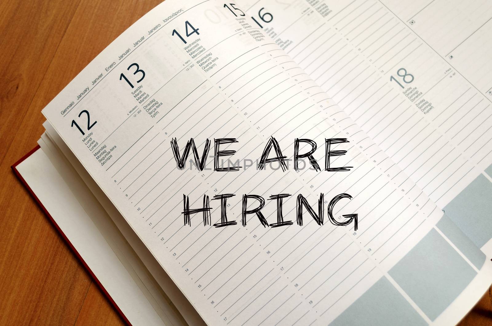 We are hiring text concept write on notebook