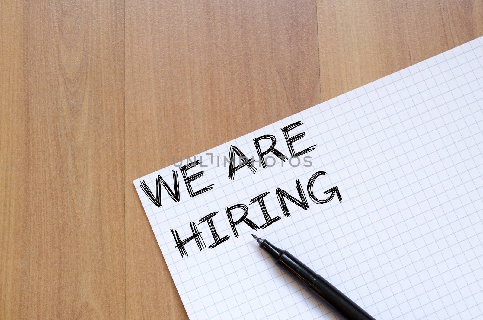 We are hiring text concept write on notebook with pen