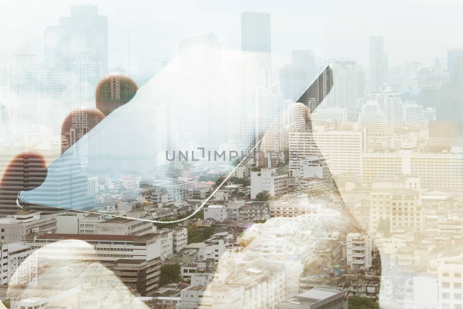 Double exposure of cityscape and smart phone, business technology concept.