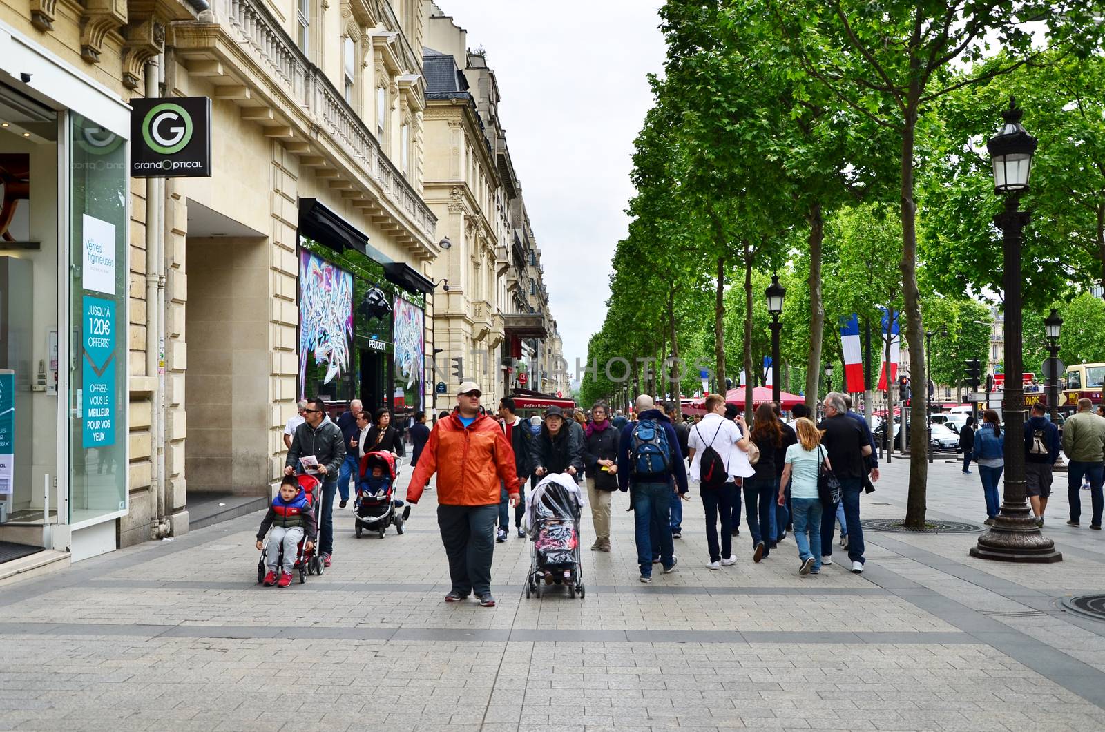 Paris, France - May 14, 2015: Local and tourists on the Avenue des Champs-elysees on May 14, 2015.The Avenue is one of the most famous streets in the world for upscale shopping.