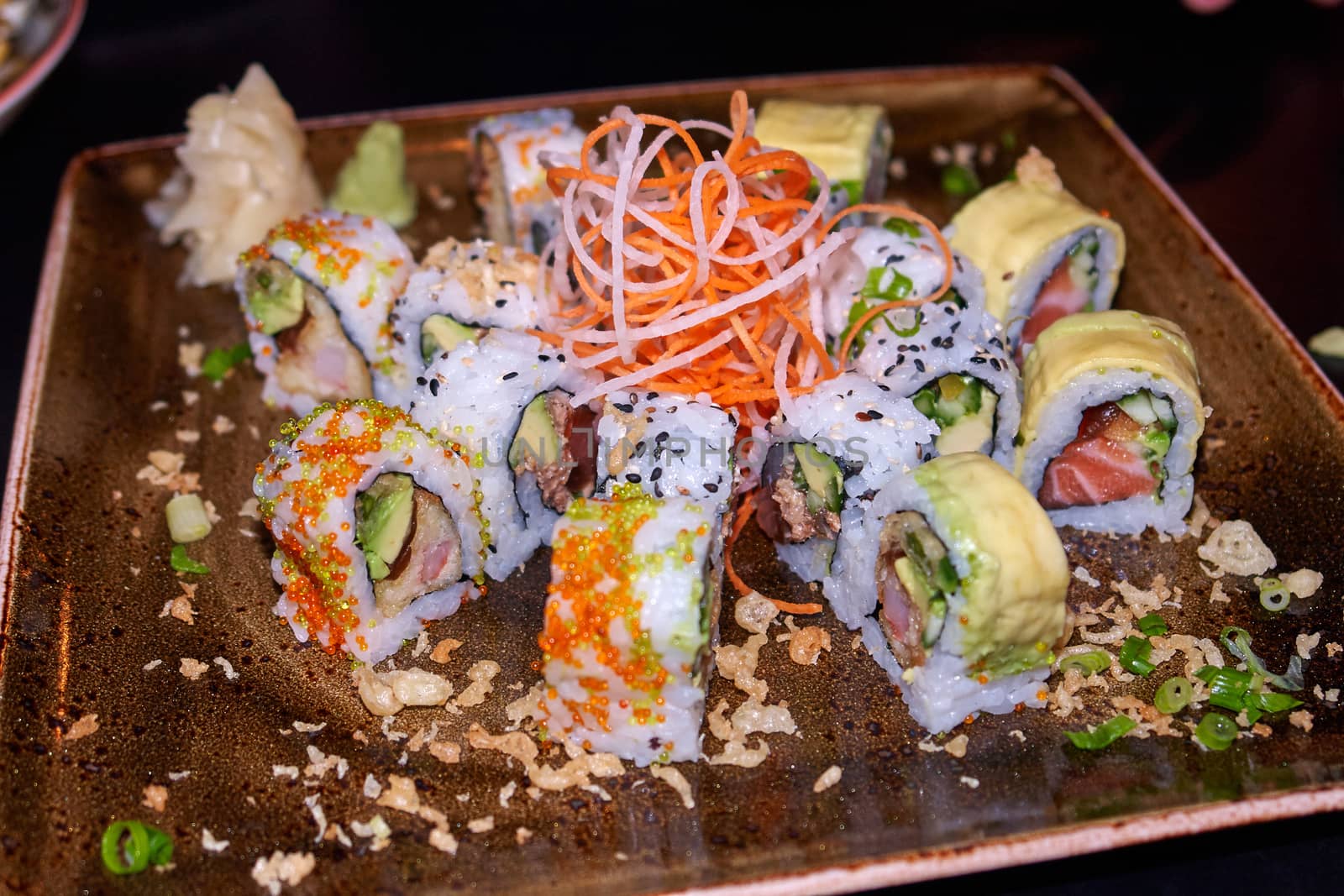 Sushi typical Japanese food served on a plate in a restaurant                              