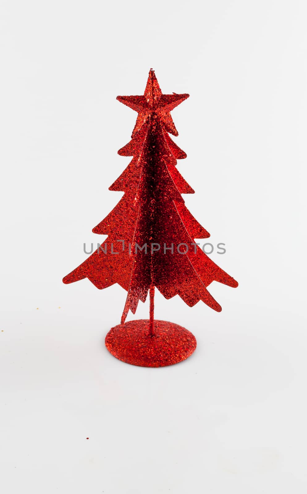 Little, red metallic christmas tree on white background