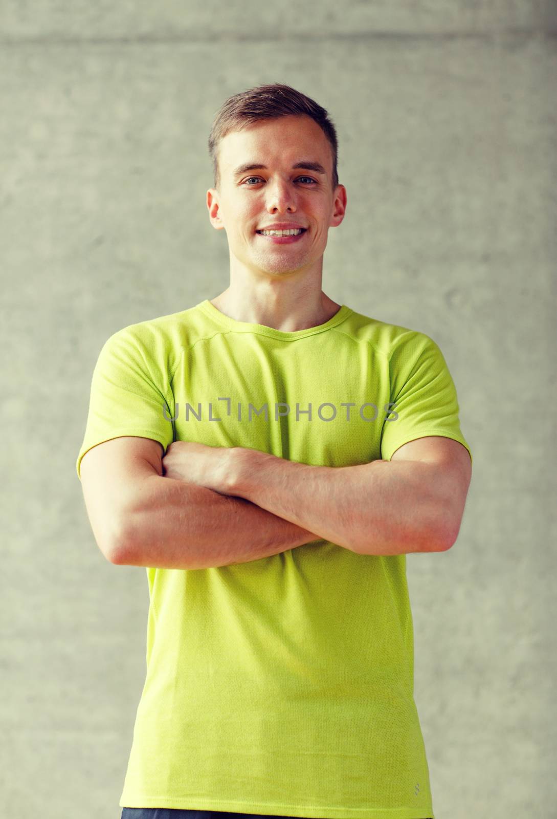 sport, fitness, lifestyle and people concept - smiling man in gym