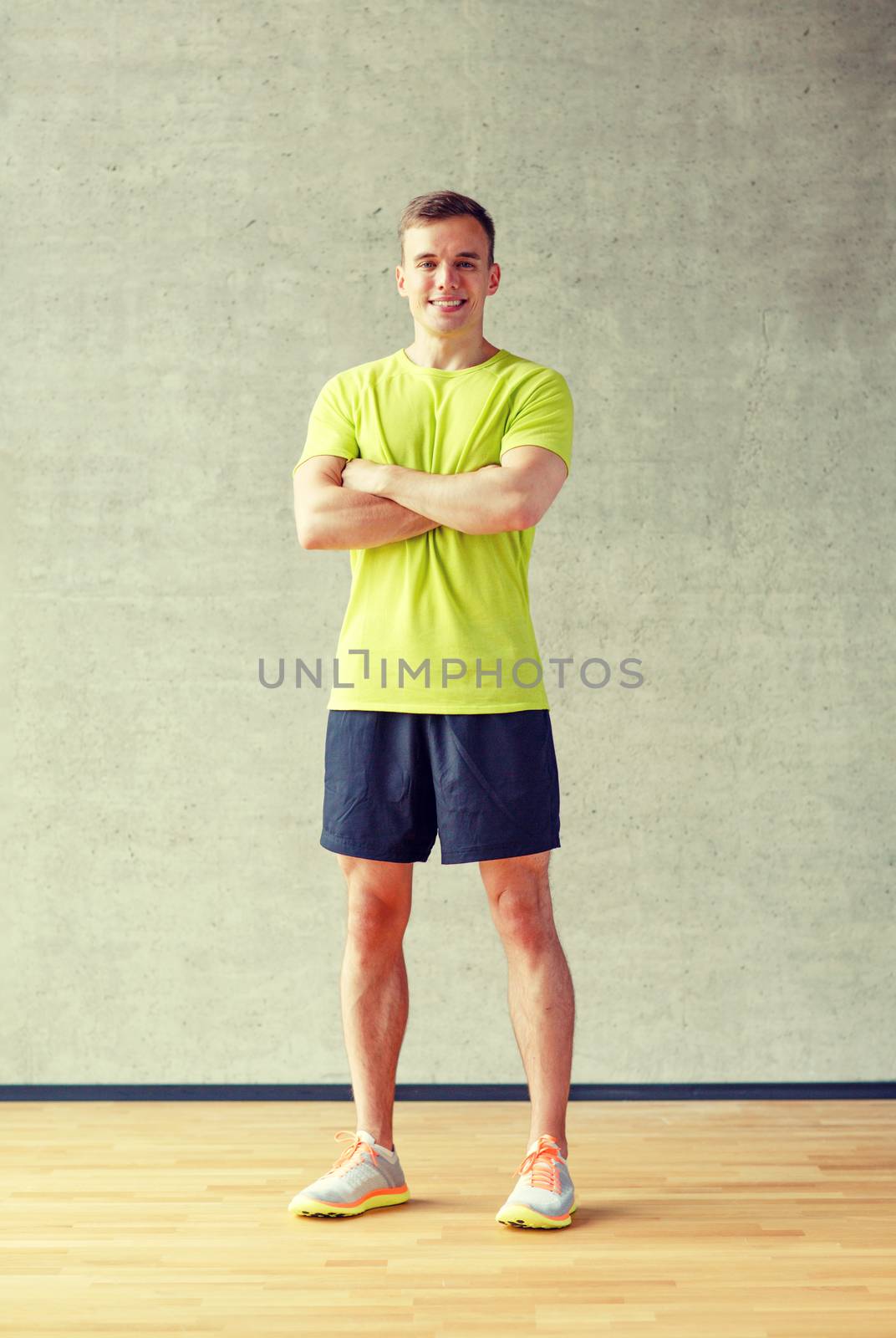 smiling man in gym by dolgachov