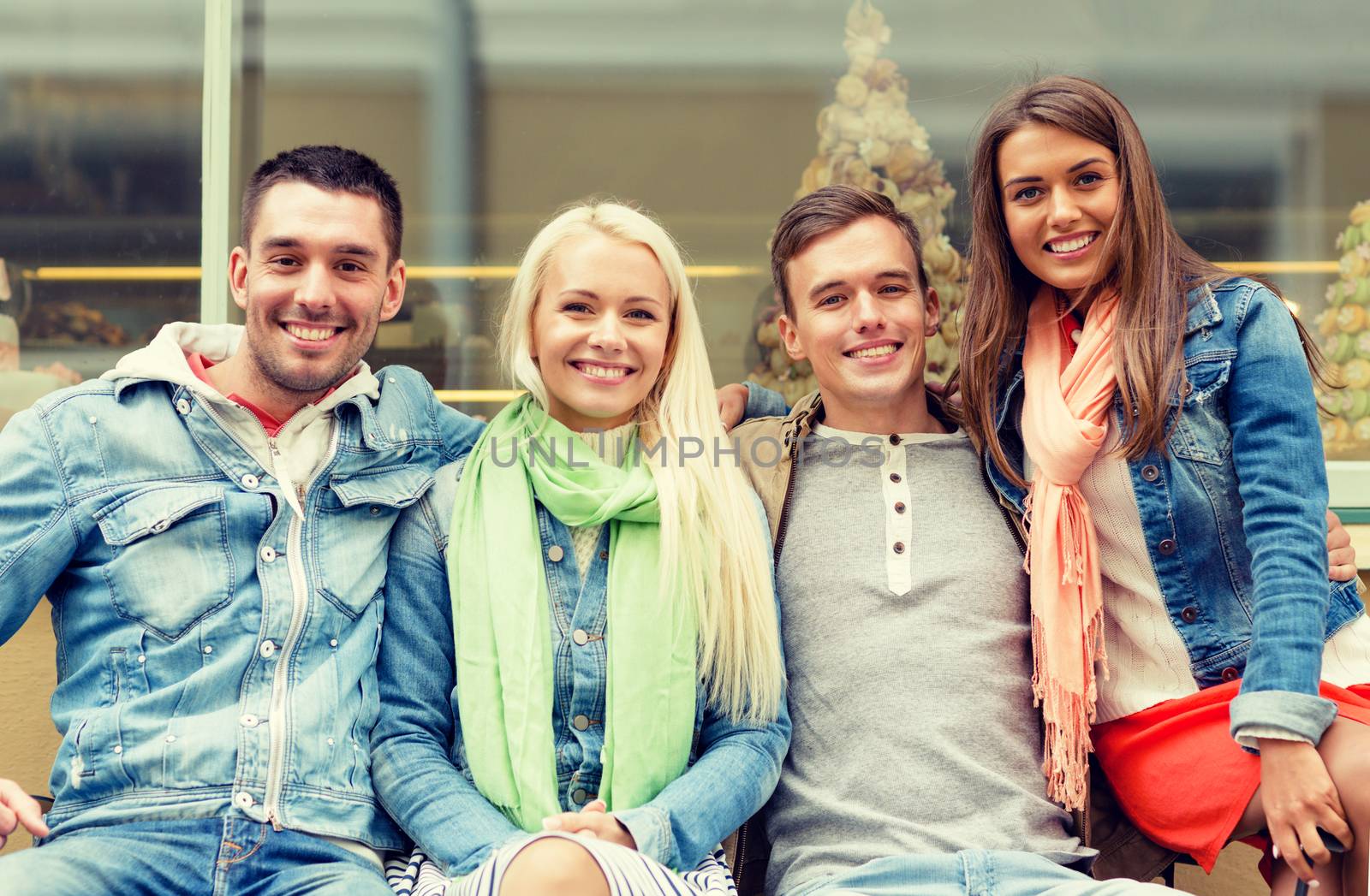 group of smiling friends in city by dolgachov