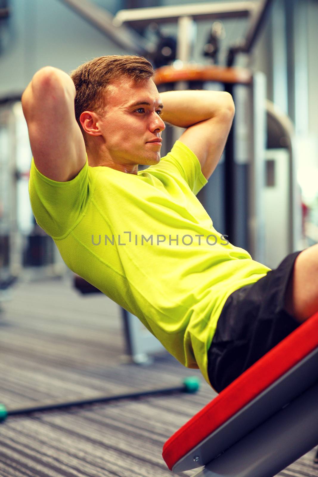 sport, fitness, lifestyle and people concept - man exercising in gym