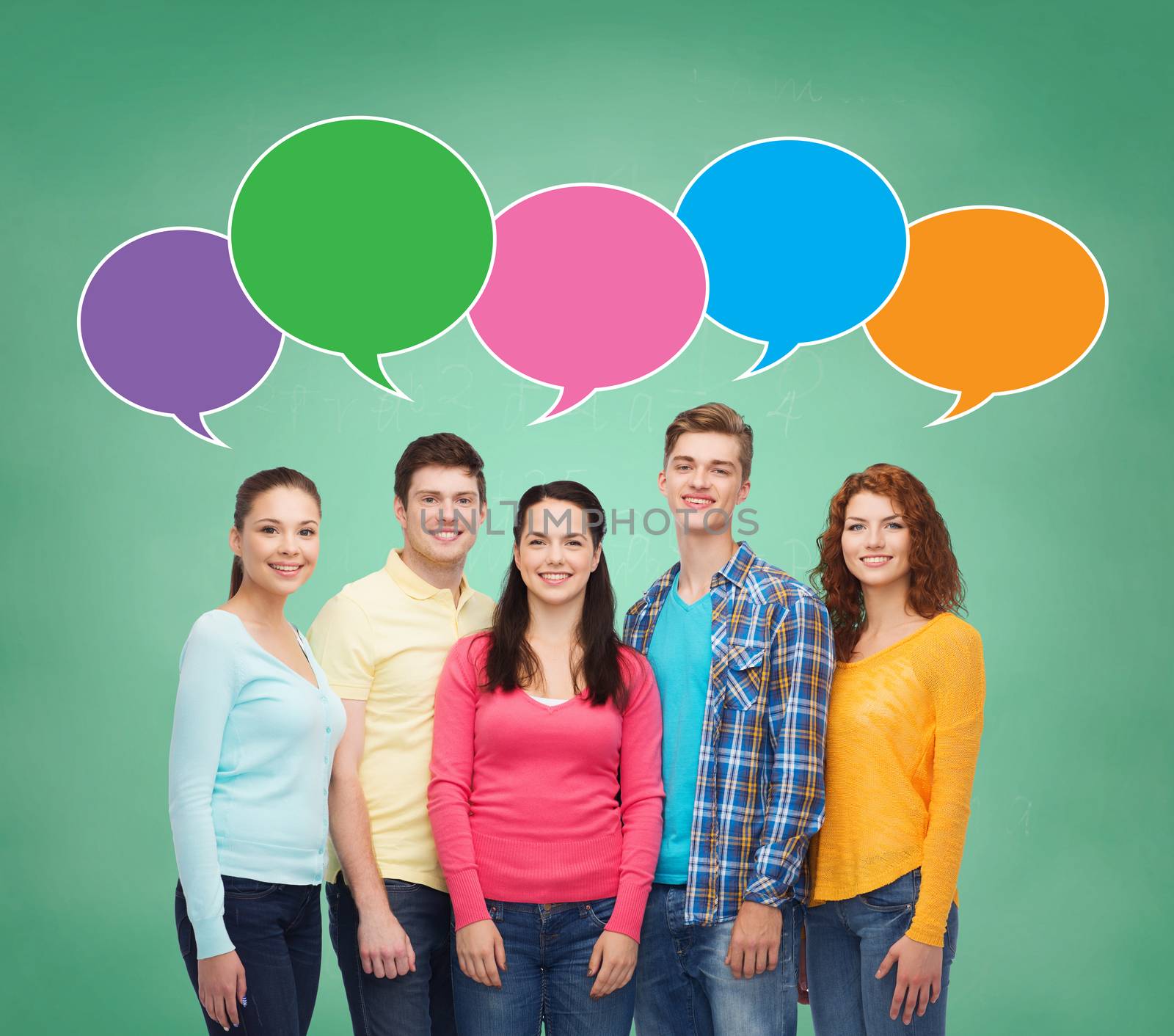 school, education, communication and people concept - group of smiling teenagers over green board background with text bubbles