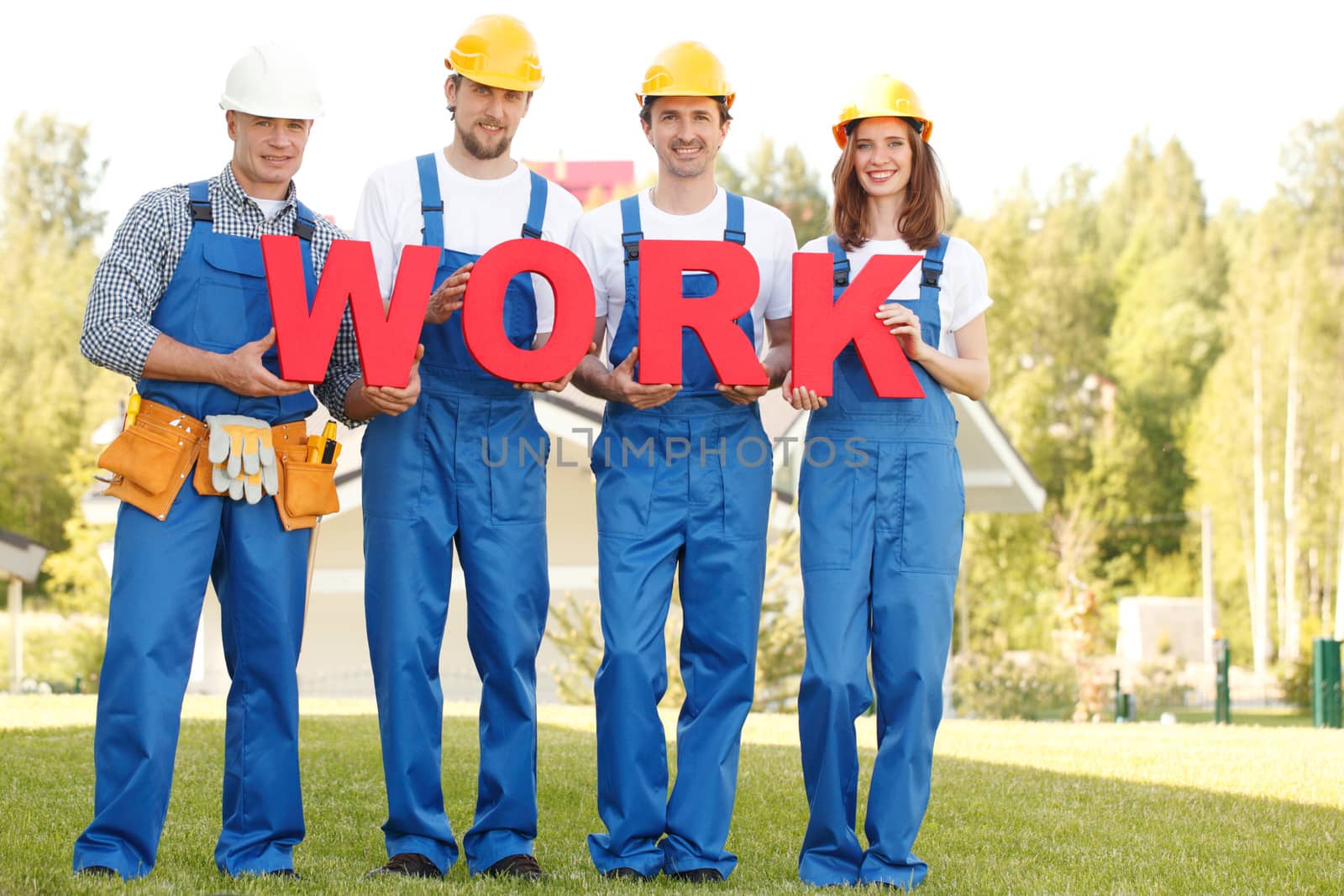 Group of workmen with word work outdoors