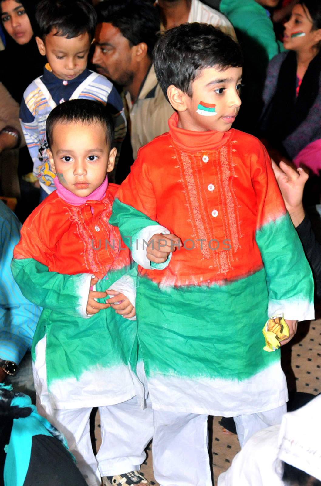 PAKISTAN, Karachi: Two children are among the crowds of people gather on December 6, 2015 to celebrate the victory of Muttahida Qaumi Movement (MQM) by waving flags and dressing in the party's colours.  The MQM rejoiced over its massive victory in the third and final phase of the local government polls. The crowd gathered in Karachi's Jinnah ground while fireworks were also displayed. The results are unofficial and inconclusive but will be announced tomorrow as well as the mayor of Karachi. 