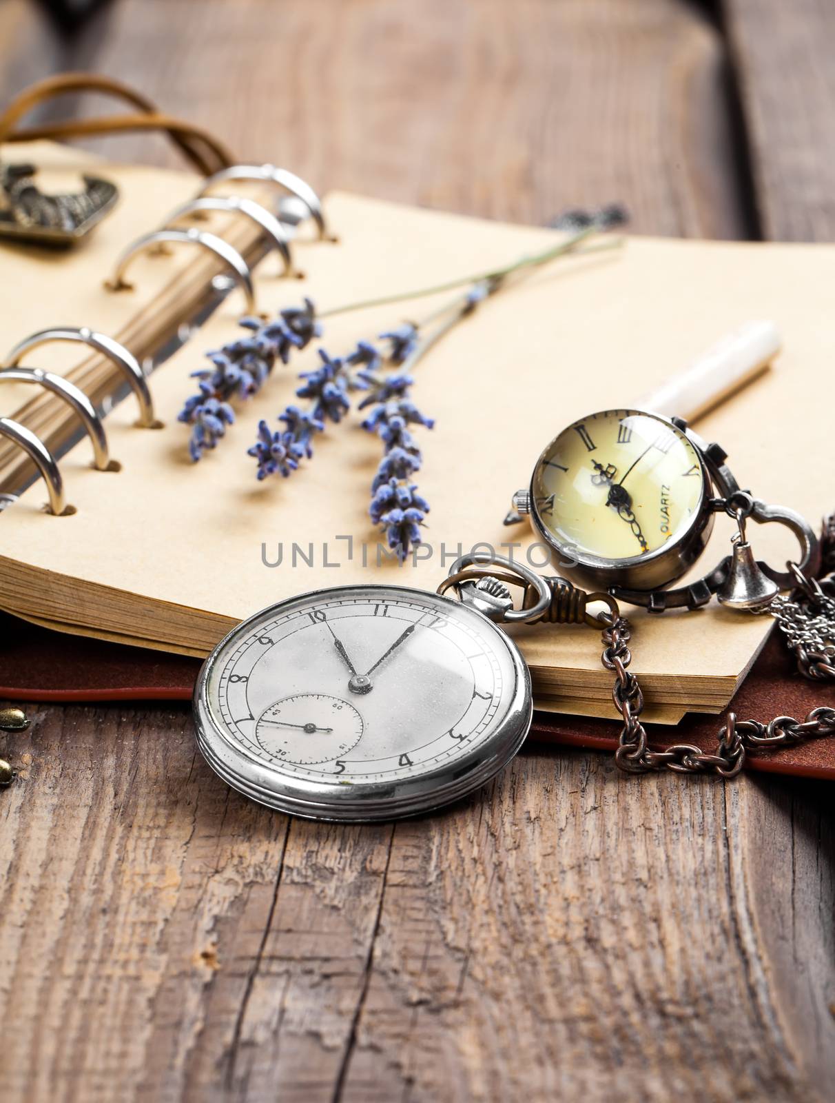 Vintage grunge still life with pocket watch, lavender flower and by motorolka