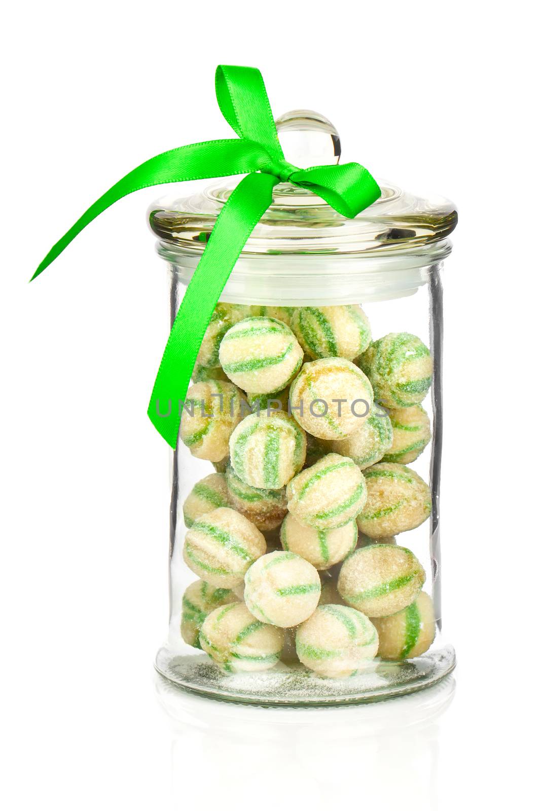 Photograph of a beautiful jar full of colorful candies, on a whi by motorolka