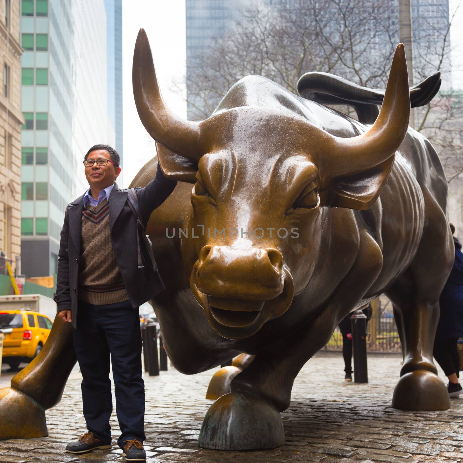 NEW YORK CITY - MAR 26: The landmark Charging Bull in Lower Manhattan represents aggressive financial optimism and prosperity March 26, 2015 in New York, NY, United States of America.