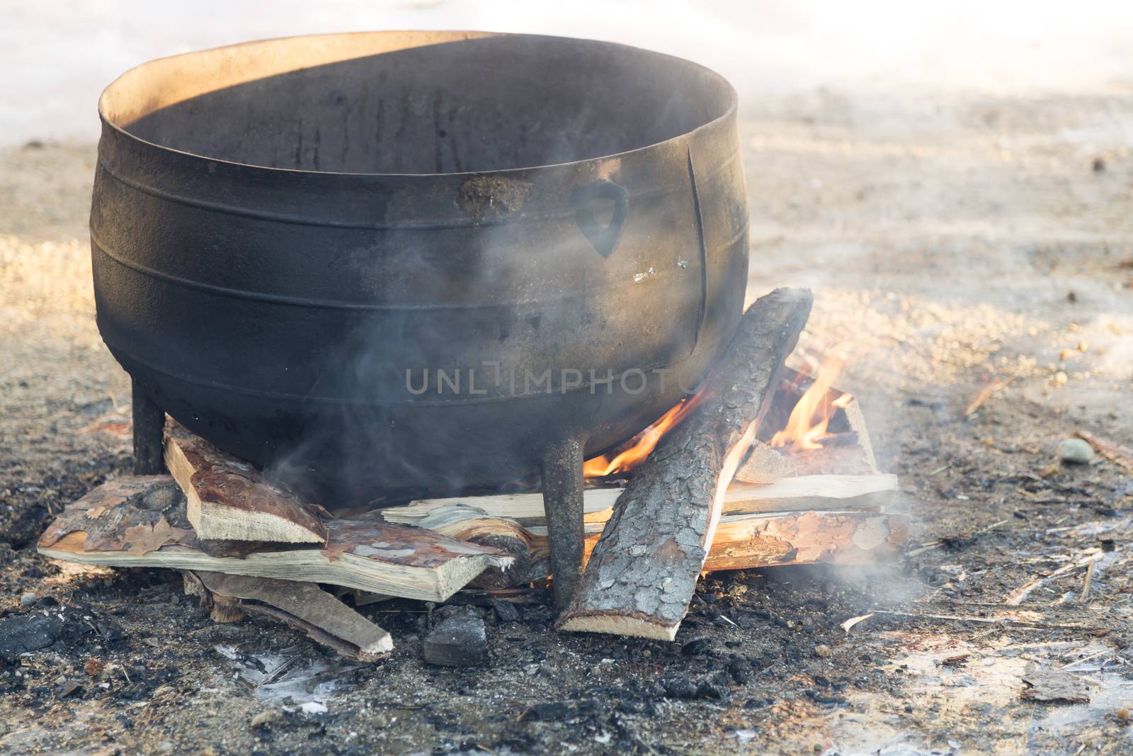 Black kettle on fire pit.