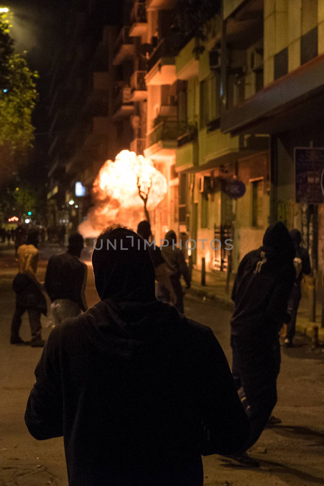 GREECE, Athens: Fire burns in the streets during clashes between protesters and police after a march marking the seventh anniversary of the police shooting of Alexis Grigoropoulos in Athens on December 6, 2015. Thousands of protesters converged on Syntagma Square earlier in the day before violence erupted in Exarcheia, the neighbourhood where Grigoropoulos, then 15, was fatally shot by police on December 6, 2008. 