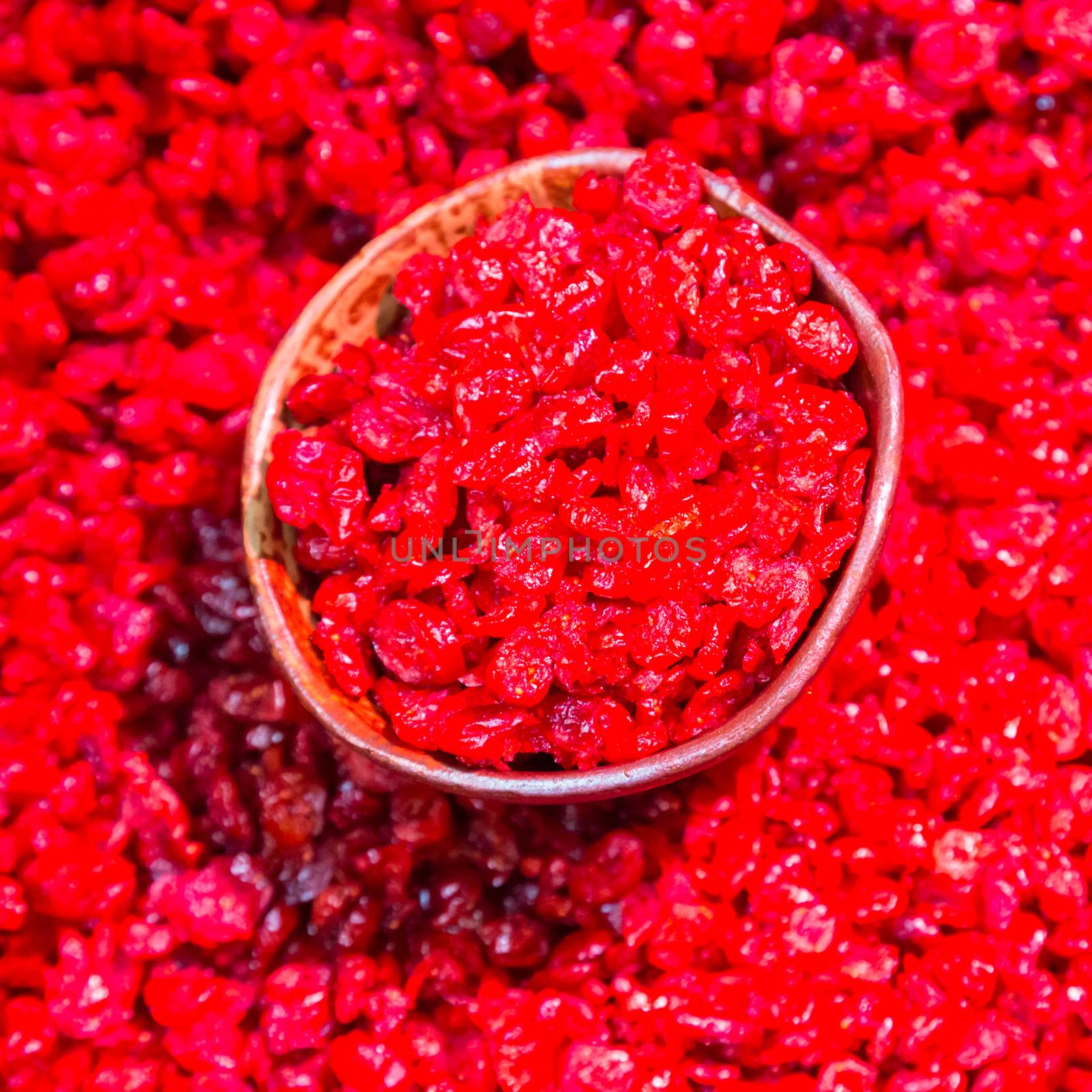 Scoop of dried cranberries beeing sold on local food market.