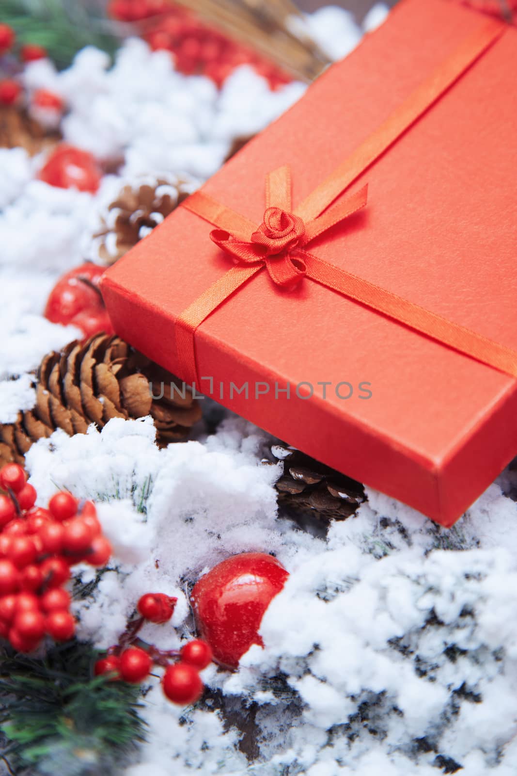 Christmas gift in a red box. Close-up vertical photo