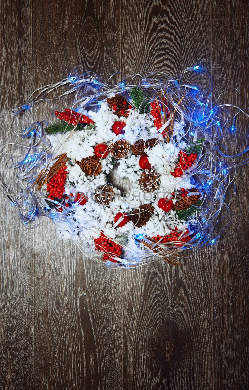 Christmas wreath and light on a hardwood background